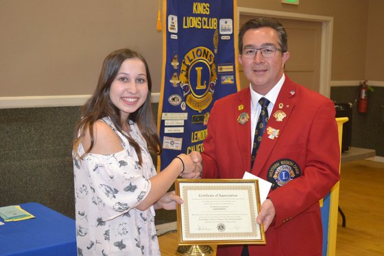 Riverdale High student earns top honors at Kings Lions' Speech Contest Wednesday Riverdale's Laila Roltin, 17, is congratulated for her speech by Kings Lions Club speech coordinator Jeff Garcia.
